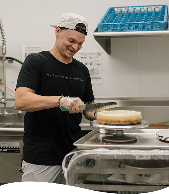 Incubator Kitchen member making a cake