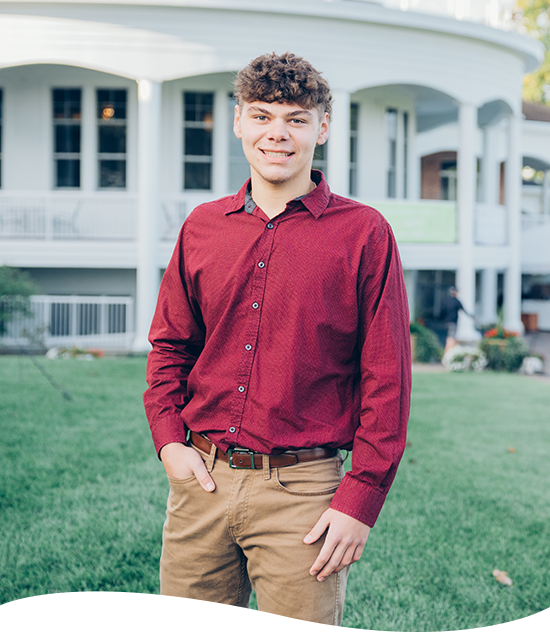 Young man standing in front of a house