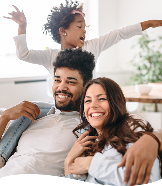 Family smiling on a couch